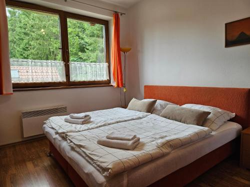 a bedroom with a bed with two towels on it at Fatrapark 1 Apartments in Ružomberok