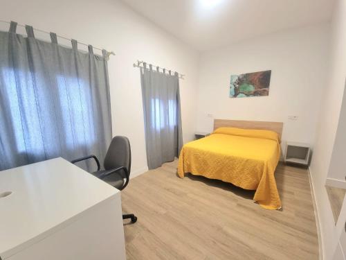 a bedroom with a bed with a yellow bedspread at Vivienda El Viajero in Valverde