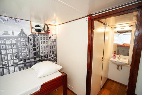 a small room with a bed and a sink at Neptune Boatique Hotel Amsterdam in Amsterdam