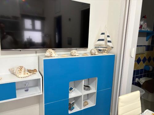 a blue cabinet in a room with a window at La Stanza del Mare in Calasetta