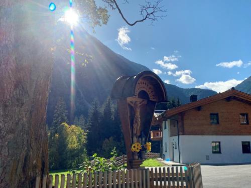 a building with a fence and a mountain in the background at Chalet in Krimml near Ski Slopes in Krimml