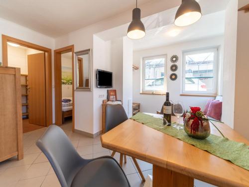 a kitchen and dining room with a table and chairs at Apartment in Hollersbach near Ski Lift in Hollersbach im Pinzgau