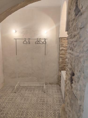 a bathroom with a shower in a stone wall at Maktub Medina in Medina Sidonia