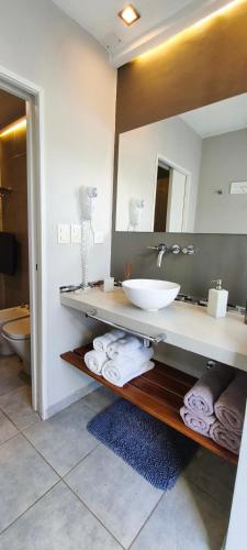 a bathroom with a sink and a mirror at Casa Cardales MINI PISCINA CLIMATIZADA in Sierra de la Ventana