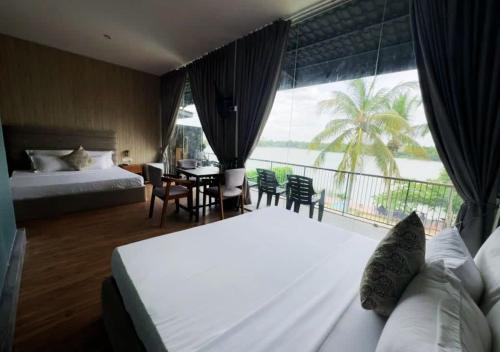 a hotel room with a bed and a large window at Diyakawa Boutique Hotel in Anuradhapura