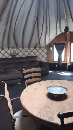 a living room with a table and a couch at Quinta de São José dos Montes in Ferreira do Zêzere