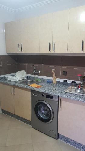 a kitchen with a washing machine and a sink at Dar omar tanger in Tangier