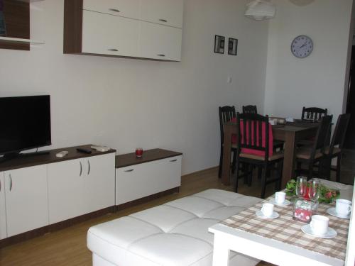 a living room with a white couch and a table at Two-Bedroom Apartment Donika in Tsarevo