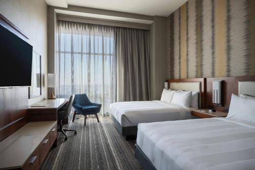 a hotel room with two beds and a television at Kansas City Marriott Downtown in Kansas City