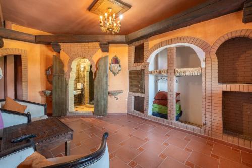 a room with a fireplace and a table and chairs at Lakala Complexe Touristique in O Ben Slimane