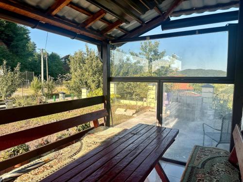 a window with a wooden bench and a view of a street at Hilltop Family House Panoramic Views in Dobrnja