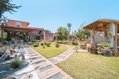 a backyard with a stone pathway and a house at Lakala Complexe Touristique in O Ben Slimane