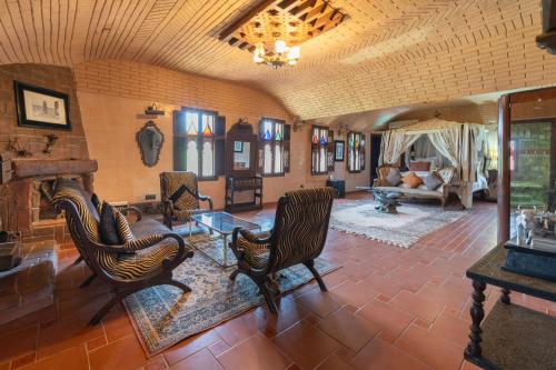 a living room with chairs and a table at Lakala Complexe Touristique in O Ben Slimane