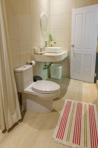 a bathroom with a white toilet and a sink at Modern Bungalows in Ko Chang