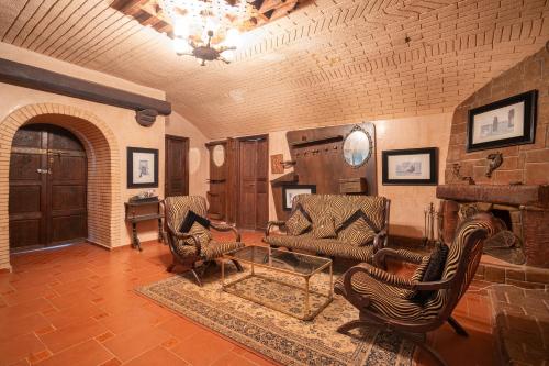 a living room with chairs and a fireplace at Lakala Complexe Touristique in O Ben Slimane