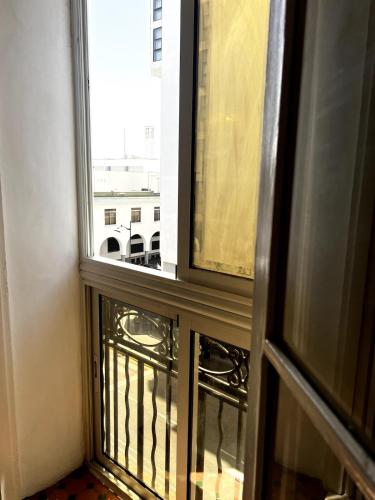 an open window with a view of a building at Dar EL BAHIA - Spacious flat with large Terrace in Casablanca