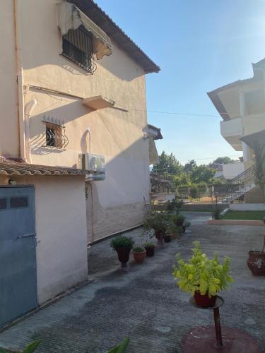 a building with potted plants on the side of it at Soula House in Kavallárion