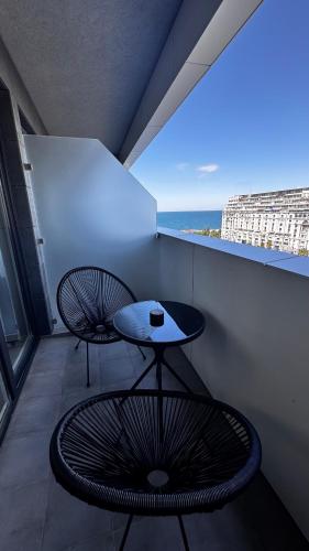 a room with a table and a chair on a balcony at Annabelle Studio in Batumi