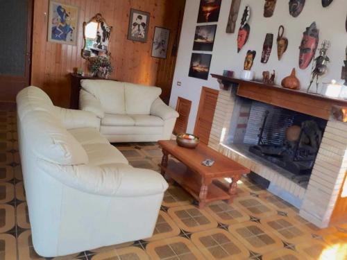 Una sala de estar con dos sillas y una chimenea. en Holiday home in Magione above lake Trasimeno, en Magione
