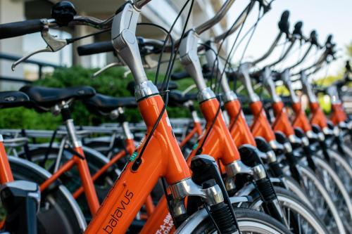 a row of orange bikes parked next to each other at Van der Valk Hotel Sassenheim - Leiden in Sassenheim