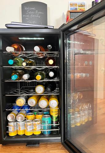an open refrigerator filled with lots of drinks at Taigh Tuaram in Carloway