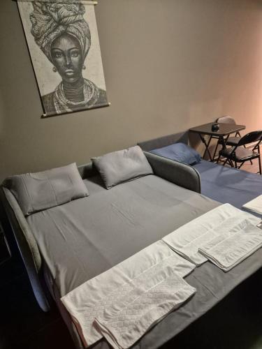 a bedroom with a bed with a bust of a woman at Meli Deluxe in Prizren