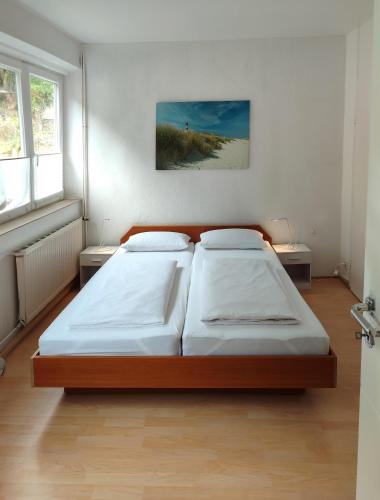 a bedroom with a large bed in a room at Gästehaus Herda in Briedel