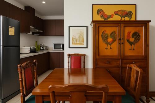 a kitchen with a wooden table and a refrigerator at 康宿 滄海居 Sea Horizon in Sampong