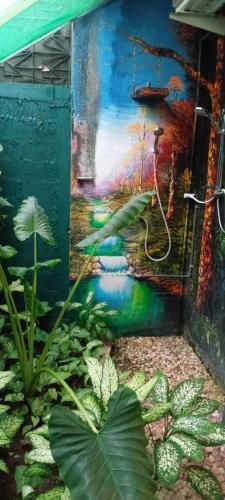 a painting on the side of a building with plants at Queens Leisure Villa Bambukuliya in Kochchikade
