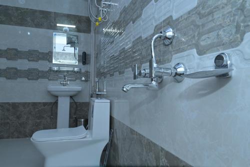 a bathroom with a toilet and a sink at Neha Homestay in Shimla