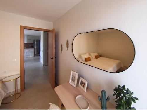a bedroom with a large mirror on the wall at Luminoso piso con vistas privilegiadas. in Santa Cruz de Tenerife
