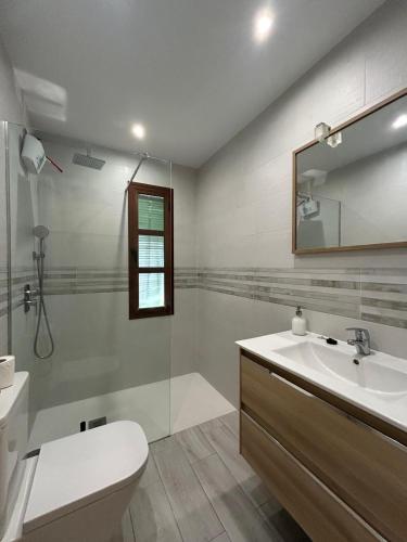 a bathroom with a sink and a toilet and a mirror at Valleverde Apartment in Mijas Costa