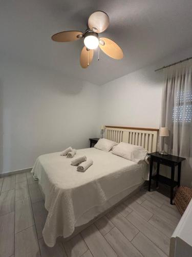 a bedroom with a bed with a ceiling fan at Valleverde Apartment in Mijas Costa