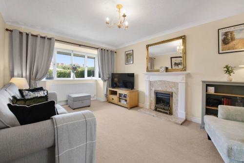a living room with a couch and a fireplace at WhiskAwayStays Toulouse Drive in Norton Junction