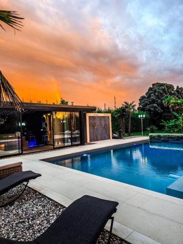 a swimming pool in front of a house at CasaKadd002LuxuryHeated Pool Garden Patio Barbeque in Civé