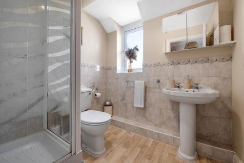 a bathroom with a toilet and a sink and a shower at WhiskAwayStays Toulouse Drive in Norton Junction