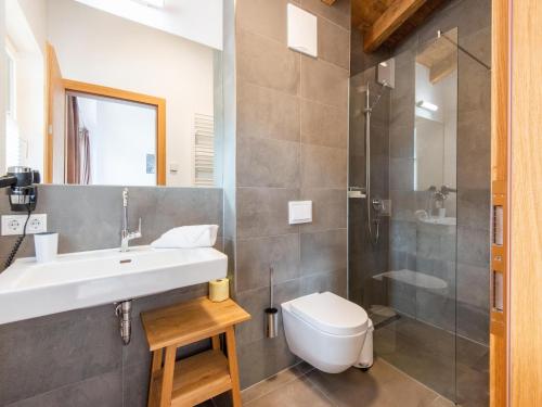 a bathroom with a sink and a toilet and a shower at Chalet in Niedernsill near Ski Slopes in Niedernsill
