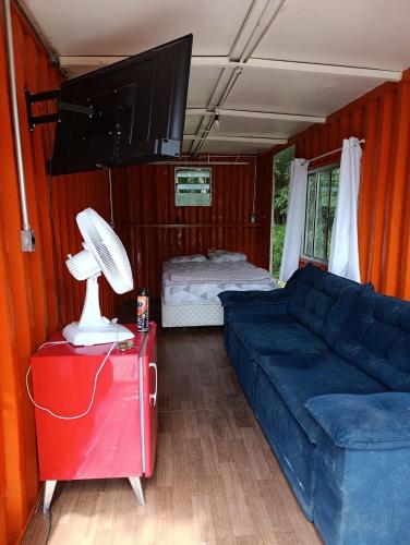 a living room with a couch and a flat screen tv at Made in Roça in Piedade