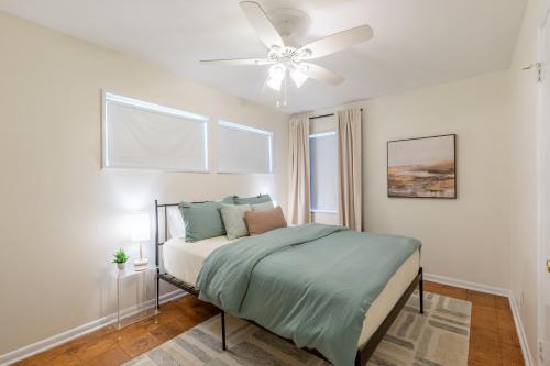 a bedroom with a bed and a ceiling fan at Modern in the Magic City in Irondale