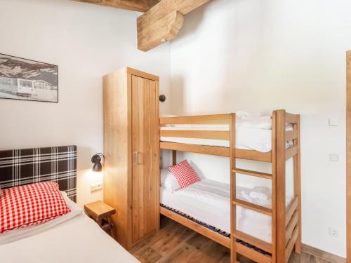 a bunk bed room with two bunk beds and a ladder at Chalet in Niedernsill near Ski Slopes in Niedernsill