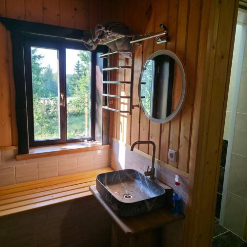 a bathroom with a sink and a mirror and a window at Садиба Сенчина in Utoropy