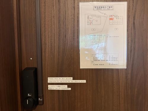 a door with a poster and a speaker on it at Tsuyukusa in Takayama