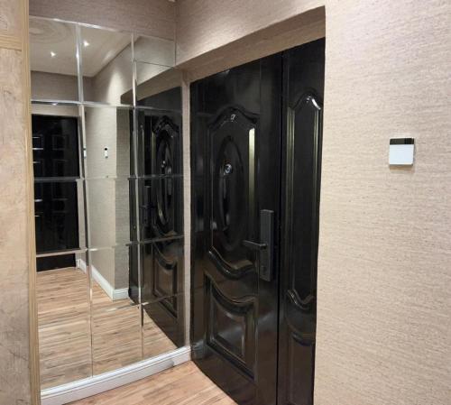 a large black closet with glass doors in a room at Molo Apartments in Lekki