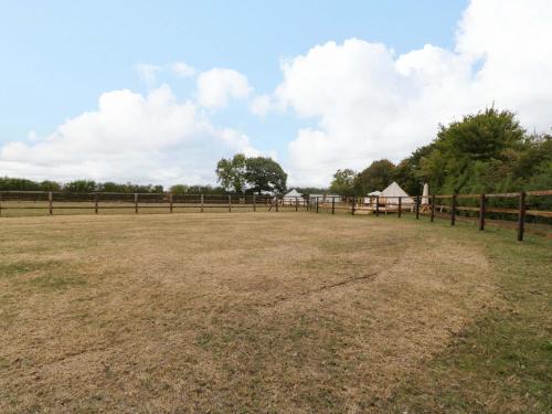 a large field with a fence and a tent at Bell 3 in Cirencester