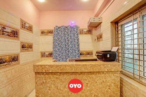 a kitchen with a counter top with a stove at Hotel O Kalinga Inn in Bhubaneshwar