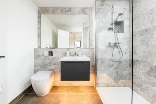 a bathroom with a shower and a toilet and a sink at Minety Lake 07 Lower Mill Estate The Cotswolds in Somerford Keynes