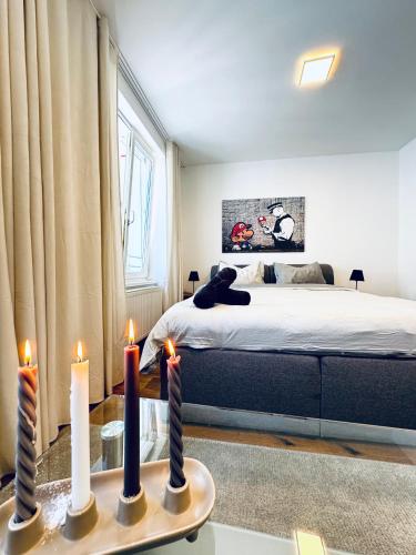a bedroom with a bed with candles on a table at Spacious 5BR shared Apartment Near Kaufpark Alterlaa in Vienna