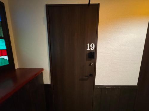 a door with the number on it in a room at Tsuyukusa in Takayama