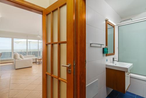 a bathroom with a sink and a mirror at Conservas Loft by Madeira Dream Stays in Paul do Mar