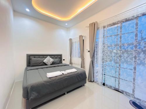 a bedroom with a bed with two towels on it at Hatyai city habibi home 1 in Sathani Hat Yai